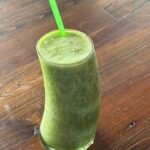 Green detox smoothie with spinach, banana, and green apple.