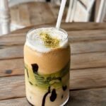 Dubai chocolate latte with pistachio cold foam and crushed pistachios.