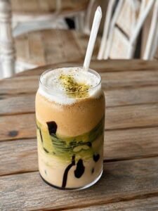 Dubai chocolate latte with pistachio cold foam and crushed pistachios.