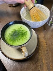 Ceremonial-grade matcha tea with vibrant green foam