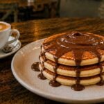 Nutella pancakes with rich chocolate spread and chocolate drizzle, served at Byte & Coffee café.